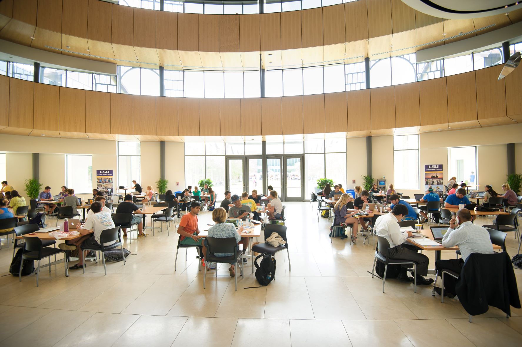 Many students sitting at tables in the BEC Rotunda