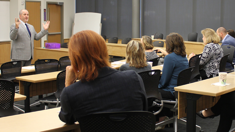 man in suit teaching in classroom