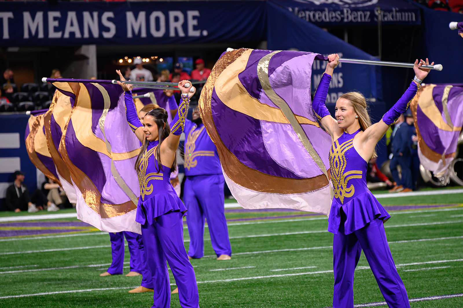 colorguard members performing at the SEC Championship Game