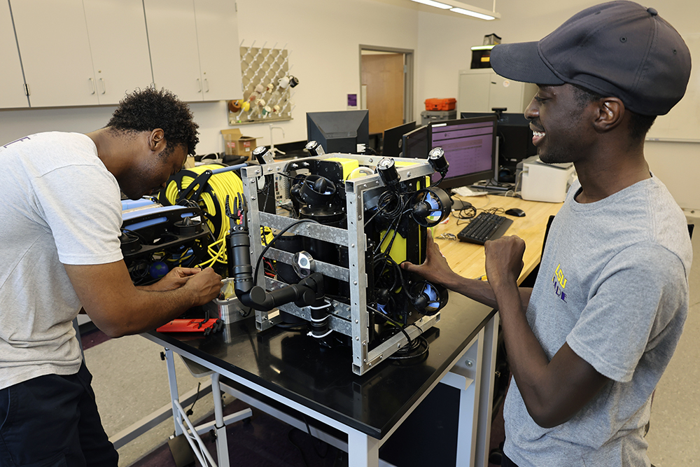 Edward Morgan and Nenyi Dadson work on marine robot