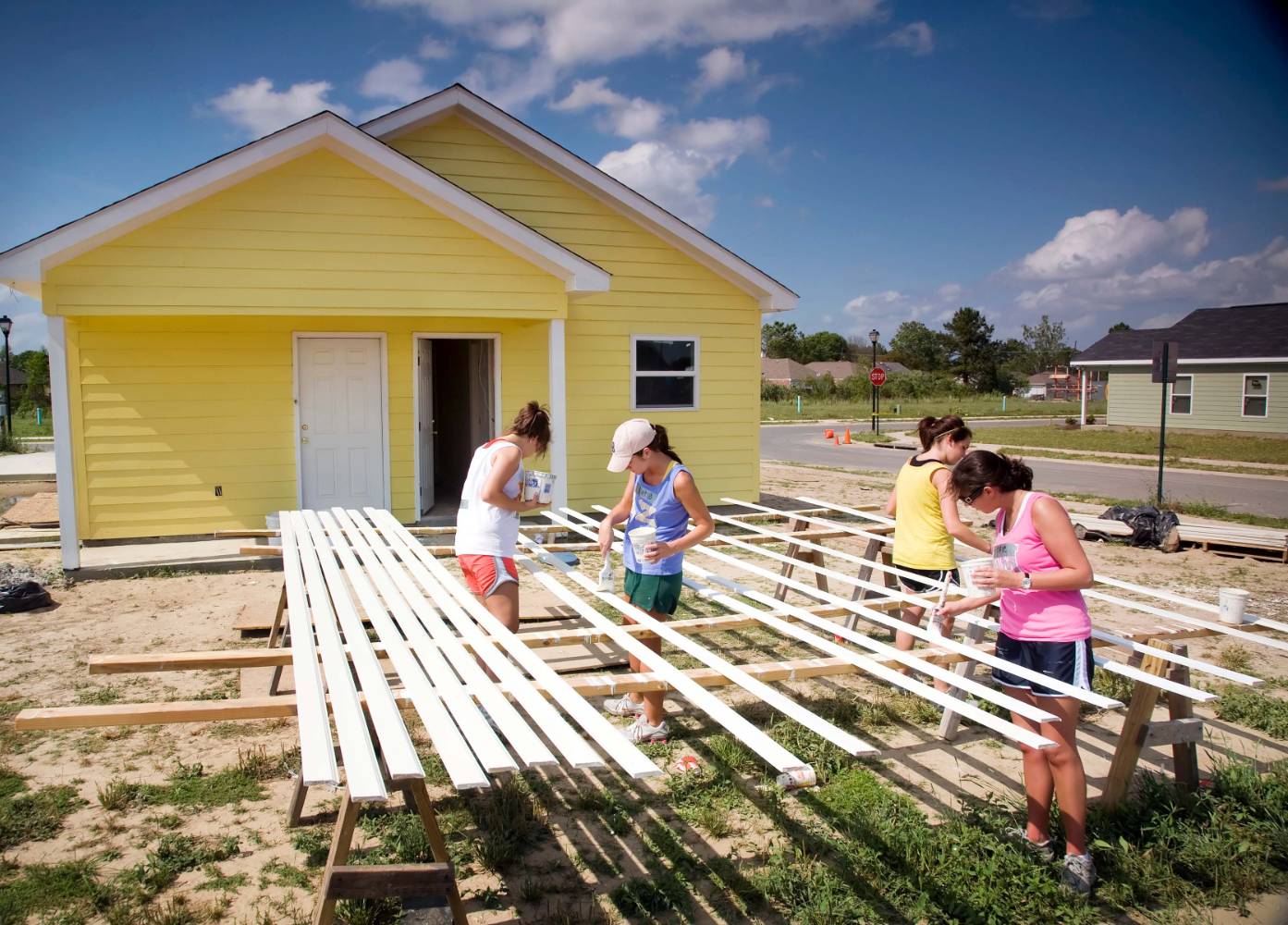 Greek members painting a house