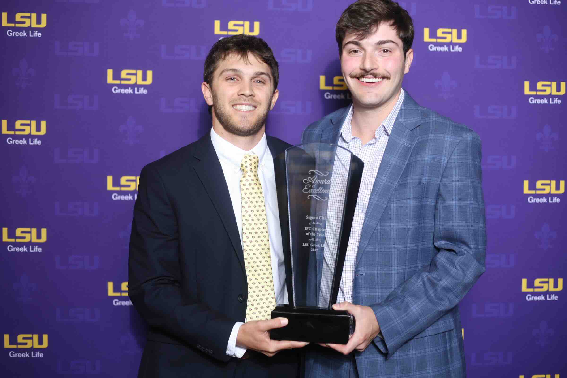 sigma chi members pose with award