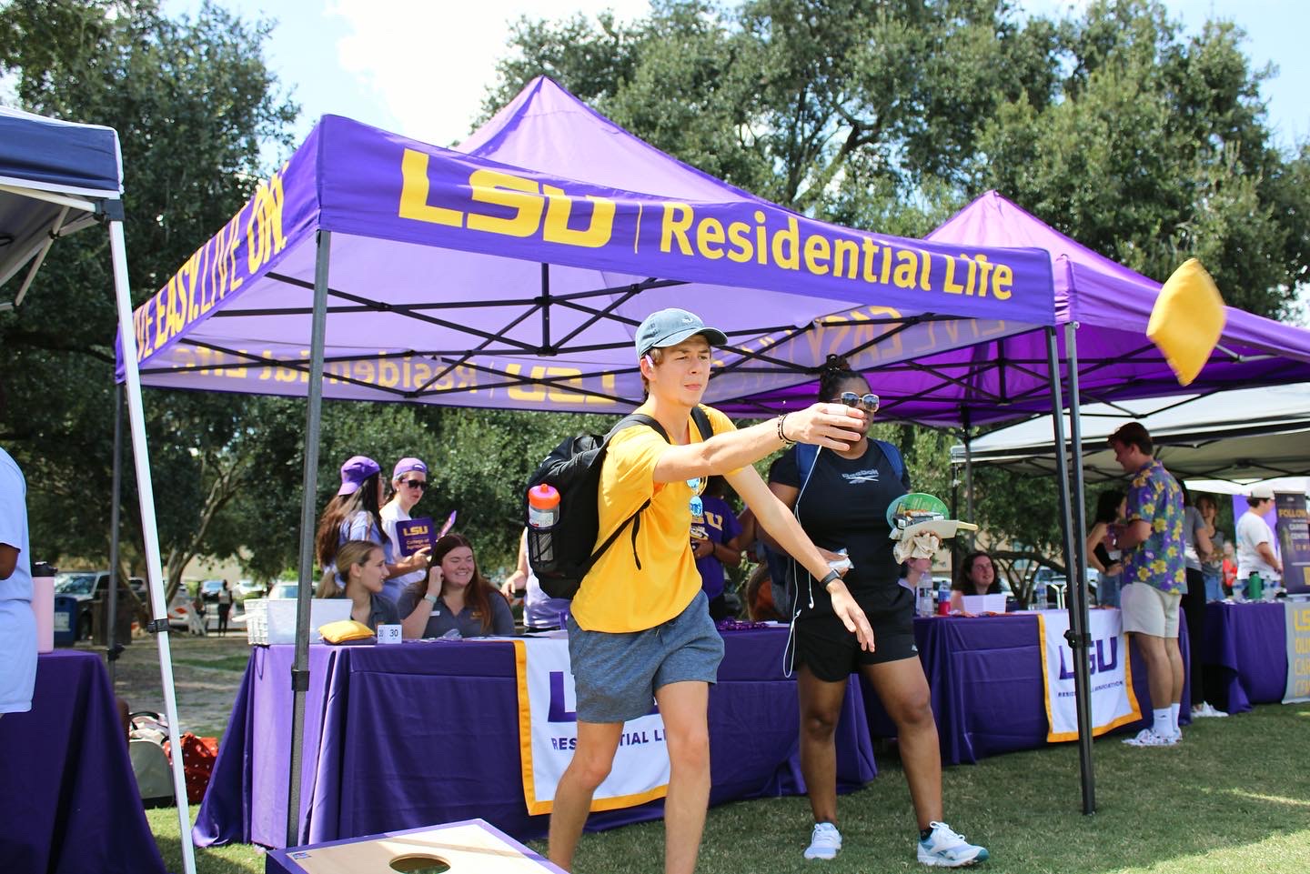 Student throwing bean bag at Fall Fest 2022