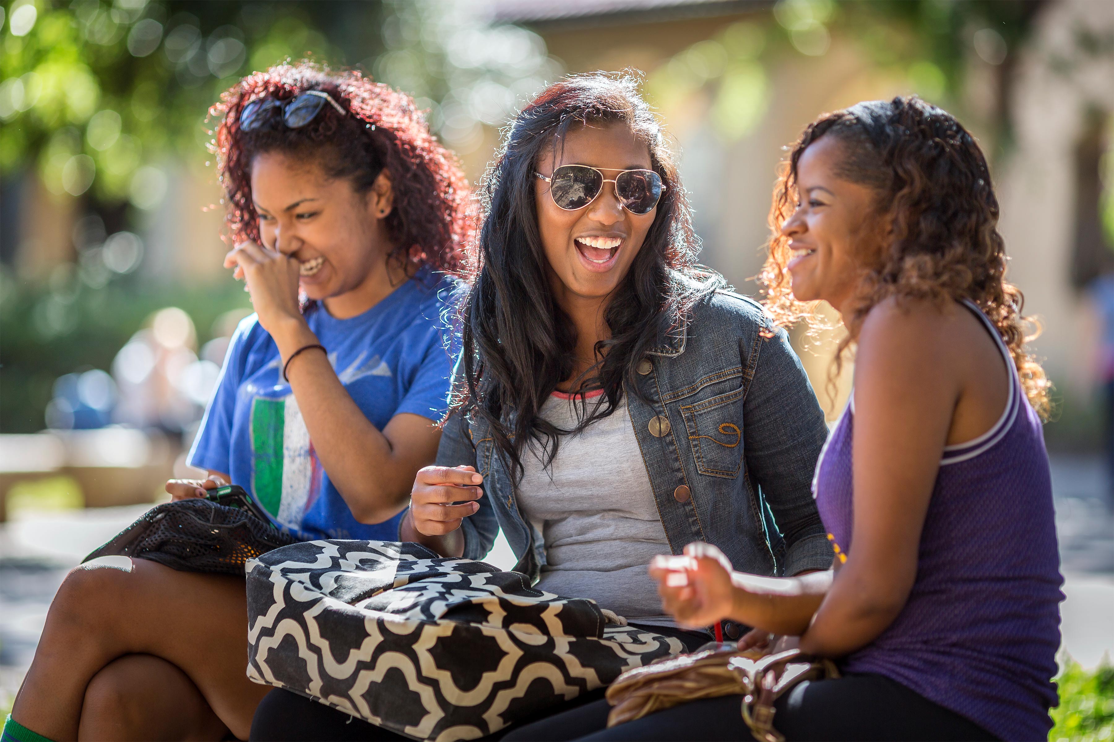 three students giggling