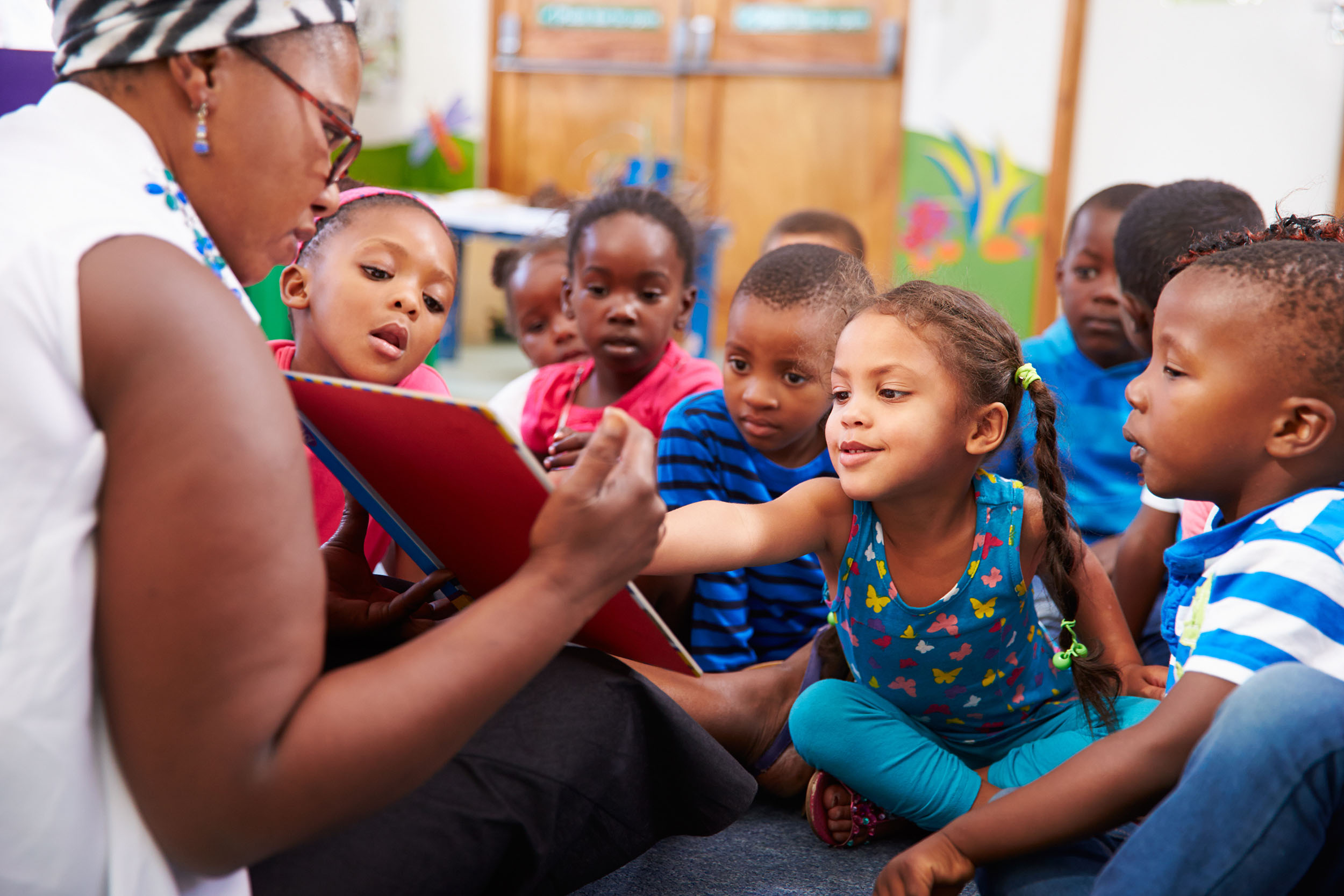 female teacher reading to class